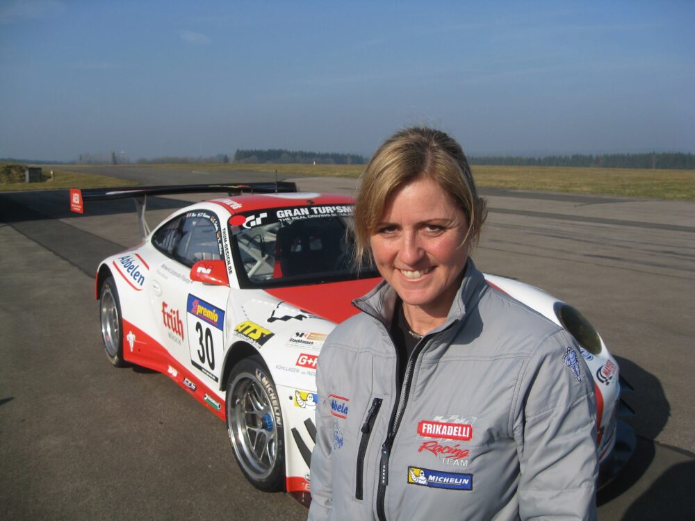 Sabine Schmitz German Racing Driver In Front of Porsche